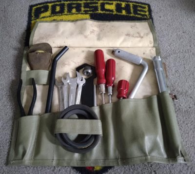 For sale : A Porsche 356A tool kit . It features a nice original bag , dressed with a new strap. It has the original Generator wrench , Mesko gauge & pouch, ,pliers & spark plug wrench, jack handle & wheel nut which are all original. It has 4 x Hazet repro spanners (not all correct sizes), 3 x repro screwdrivers and a kk 772 wheel wrench & period fan belt .