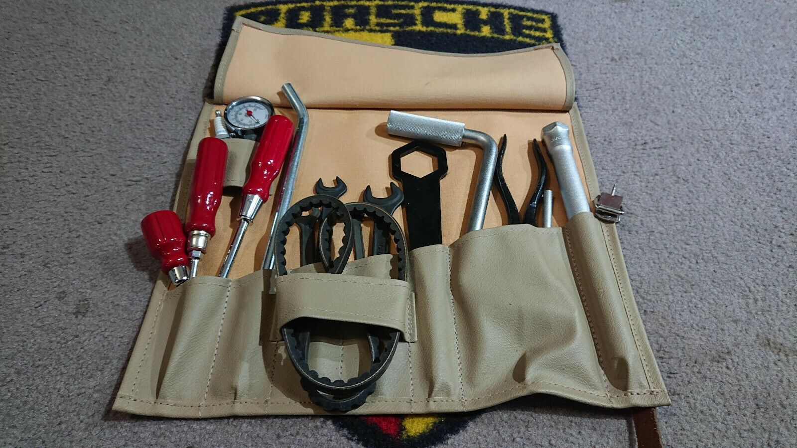 We are offering this nice reproduction tool kit for the Porsche 356A. The tool kit is complete and uses a kk tool bag and very good quality reproduction tools, Spanners and a KK exclusive plug wrench, a KK Hazet 772 wheel wrench. superb reproduction screw drivers , a KK generator wrench, restored pliers, nice original messko and a spark plug. .Includes a conti belt, tyre pressure gauge and . A great affordable tool kit that is ready to use