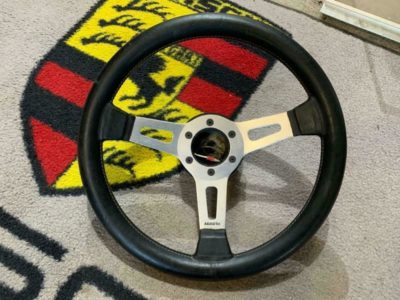 Here is a great wheel for the early Porsche 911/912 outlaw in your life!! We have a lovely 350mm Abarth silver three spoke dished wheel. The leather is in fantastic condition, it has been recently fed and is showing very light use, spokes are in superb condition with no damage. It’s fitted to an original solid MOMO hub (65-73 911/912 fitment) includes horn push .