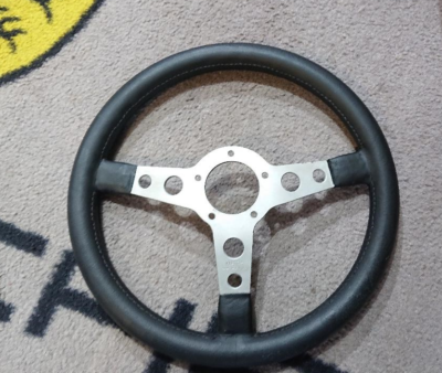 lovely Victor Alhen 350mm steering wheel . Silver spokes , 5 hole fixing , leather rim is superb , stitching is faultless . Made in Italy on the reverse. A few little marks and scratches , expected from a wheel of this age .