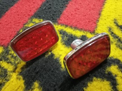 A pair of NOS Porsche 356 reflectors, Small K1315 engraved,glass lens chrome backed SWF marked 1956-59. These are NOS , Genuine not reproduction .