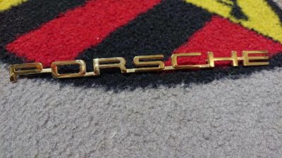 An original Porsche script 356bT6+C 200mm with R on reverse. newly gold plated . This has the R on reverse .