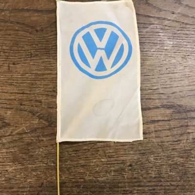 An original 1960's VW dealership desk flag. It is in very good used condition and has been in a private collections for over twenties years in a display cabinet. The flag has no hole or damage and the blue VW logo is clear, there are a couple of small stains (please view photos). The pole is a gold colored metal and in superb condition, the bottom is pointed and the other has a nice detailed top. This would have been more than likely in a VW dealership on a desk as a decorative item. It is a rare and collectible item!