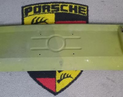 A Genuine Porsche 911 rear center panel 1965-73 . This appears to be NOS , but has had 4 small holes drilled in the number plate area. Please see pictures .