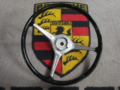 A lovely original Porsche 356 BT6 steering wheel , with its deeper dish than a BT5 , 23 finger grip , rounded spokes and painted black on the reverse . This has ha the outer rim repainted in black , a light detail and is ready to fit . Vdm hub stamped with the number 21 .