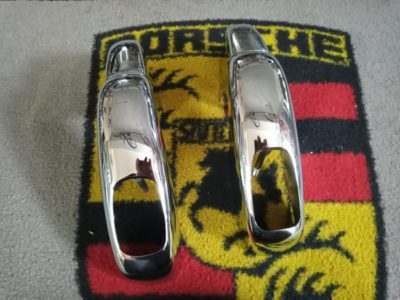 a pair of original pair of Porsche 356B/C rear bumper over riders with exhaust hole . 