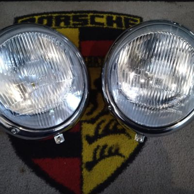 A pair of Porsche 356B/C Headlamps 1960-65 RHD (Right hand drive) , but fitted with 911 H4 peak lenses