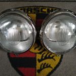 A pair of Bosch late 1950's headlamps , These feature Bosch logo original re-chromed headlamp rims , cleaned and detailed original reflectors , repainted shells , the correct aluminium spacer and screws. 12 & 9 o'clock adjustment screws and finished with NOS bulb holders and new glass . Would suit a 1956-60 Porsche 356a .