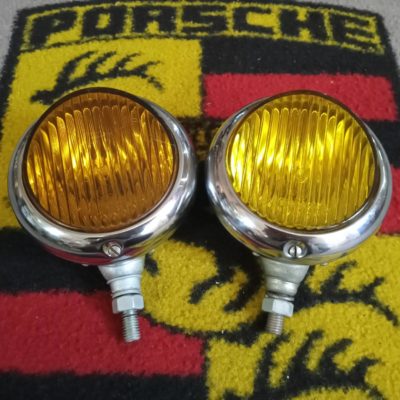 A period pair of Yellow peaked lensed spot lights, measuring 130mm diameter and a 100mm lens , a slight variation in lens colour , these are in really good condition ,