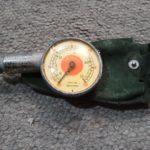 A Messko red dot dual scale tyre gauge