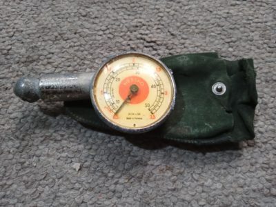 A Messko red dot dual scale tyre gauge