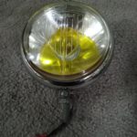 An original Marchal 642 front spot lamp ,fitted with yellow bulb . it has some light rust around the edge of the reflector , glass has no cracks or chips.