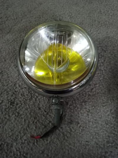 An original Marchal 642 front spot lamp ,fitted with yellow bulb . it has some light rust around the edge of the reflector , glass has no cracks or chips.