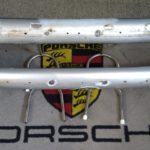A pair of good original Porsche 356/356A bumpers up to T1 models .When we got these , they needed some work to make them usable/presentable . So As you can see, holes welded & repaired. Mounts are in good order . A good strong pair of bumpers that require some minimal work .Included are those funky front bumper irons ....
