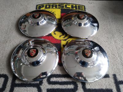 A set of 4 used Super hub caps Porsche 356A/B drum brake models . These have pitting , blemishes to the chrome etc . Badges have been touched in , good usable set on a survivor car . 